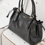 Sac à main Alba noir posé sur une chaise