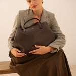 Sac cabas Mary chocolat posé sur les genoux, femme assise