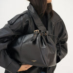 Sac à main Iria noir porté à l'épaule, vue de profil
